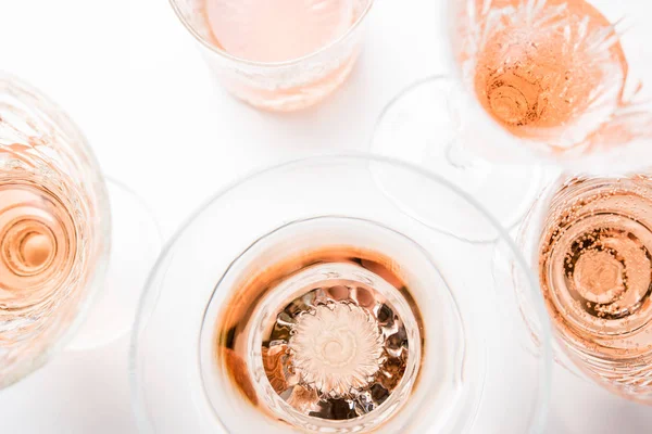 Sparkling rose wine in different glasses on white background — Stock Photo, Image