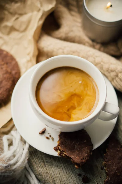 Tasse Kaffee mit Milch und Schokoladenkeksen auf warmer Wolldecke — Stockfoto