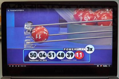 MONTREAL, CANADA - SEPTEMBER 23, 2018: Powerball lottery winning numbers and results on Youtube on a laptop screen. Powerball is a popular American lottery game offered by 44 states in USA clipart