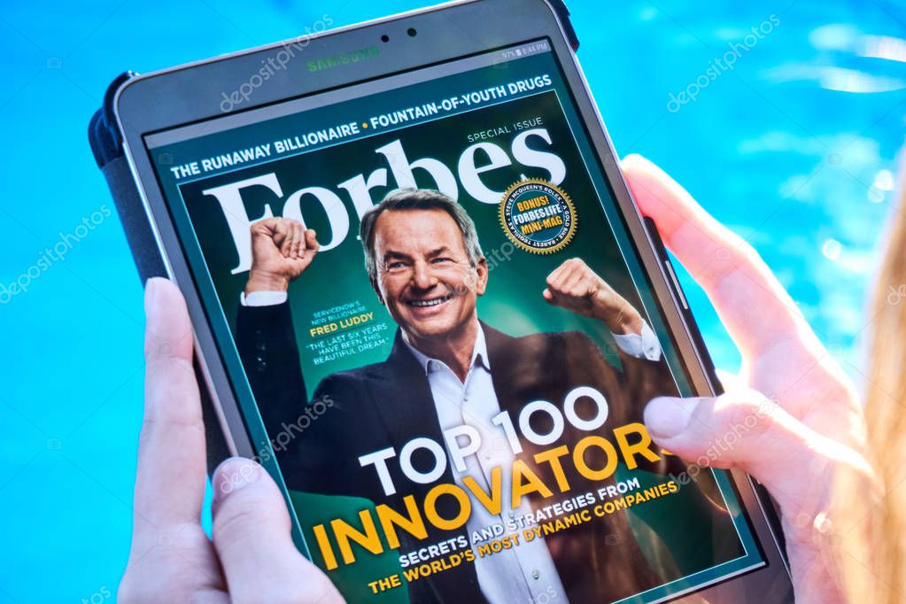 MONTREAL, CANADA - SEPTEMBER 8, 2018: Forbes magazine on a Samsung Galaxy tablet in hands.