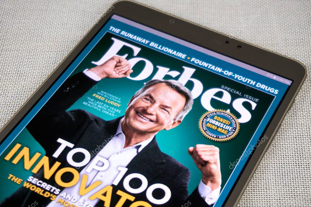 MONTREAL, CANADA - SEPTEMBER 8, 2018: Forbes magazine on a Samsung Galaxy tablet in hands.