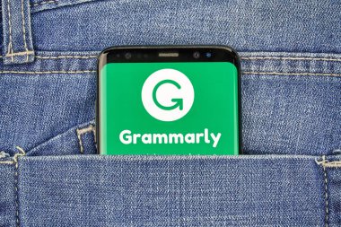MONTREAL, CANADA - OCTOBER 4, 2018: Grammarly check logo and app on a Samsung s8 screen. Grammarly is a popular English-language writing-enhancement software developed by Grammarly Inc. clipart