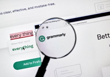 MONTREAL, CANADA - OCTOBER 4, 2018: Grammarly check web page on a PC screen under magnifying glass. Grammarly is a popular English-language writing-enhancement software developed by Grammarly Inc clipart