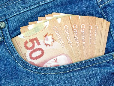 canadian money in a pocket of a blue jeans clipart