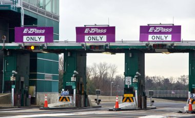 NEW YORK, USA - DECEMBER 14, 2018: EZPass signs and terminal. E ZPass is electronic toll collection system used on tolled roads, tunnels and bridges, and tunnels in the United States clipart
