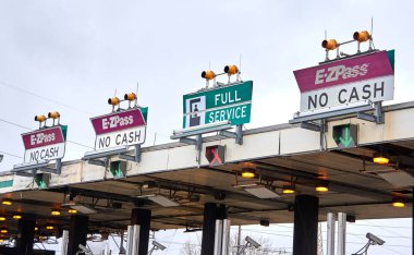 NEW YORK, USA - DECEMBER 14, 2018: EZPass signs and terminal. E ZPass is electronic toll collection system used on tolled roads, tunnels and bridges, and tunnels in the United States clipart
