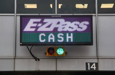 NEW YORK, USA - DECEMBER 14, 2018: EZPass sign and terminal. E ZPass is electronic toll collection system used on tolled roads, tunnels and bridges, and tunnels in the United States clipart