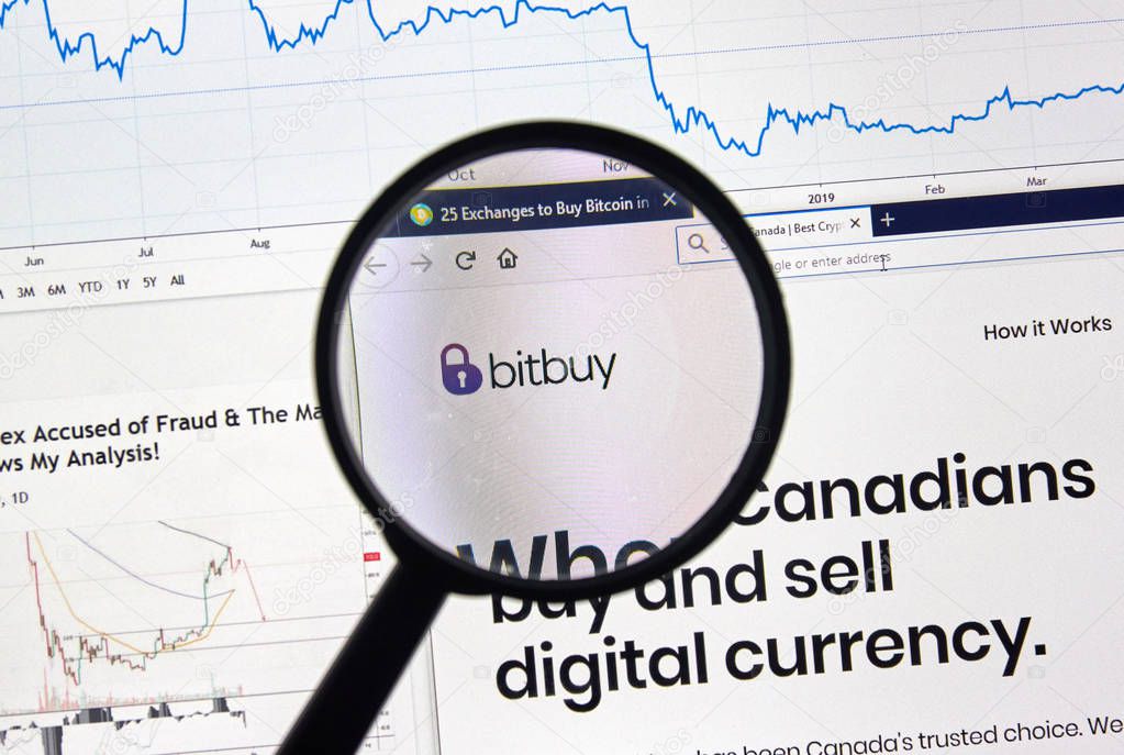 MONTREAL, CANADA - APRIL 26, 2019: Bitbuy.ca cryptocurrency digital assets exchange logo and home page on a laptop screen under magnifying glass.