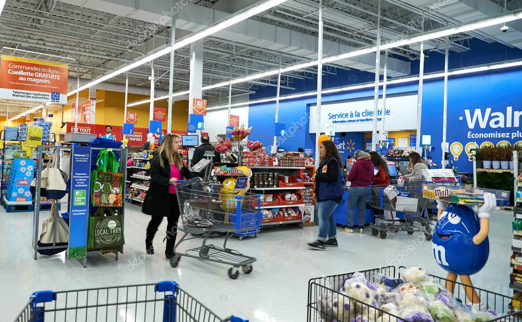 MONTREAL, CANADA - APRIL 30, 2019: People at cashier in Walmart store. Walmart is an American multinational retail corporation which operates a chain of hypermarkets.