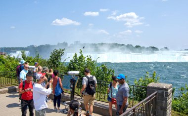 Niagara Falls, Canada - July 27, People taking selfie over Niagara Falls on a beautiful clear sunny day. Canadian view. Niagara Falls are three waterfalls at the southern end of Niagara Gorge