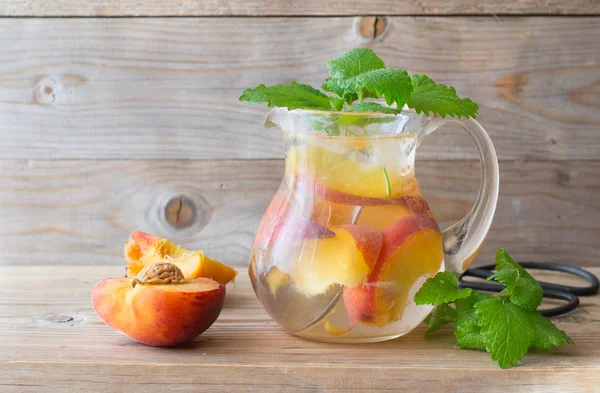 Peach infused water in pitcher