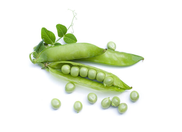 Pods of green peas with leaves on white background.