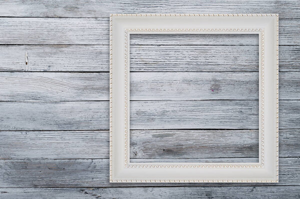 Old picture frame on vintage wood wall.