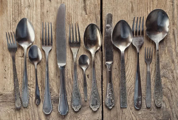 old cutlery on wooden table