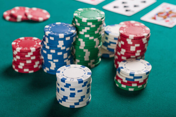 Poker chips on green background