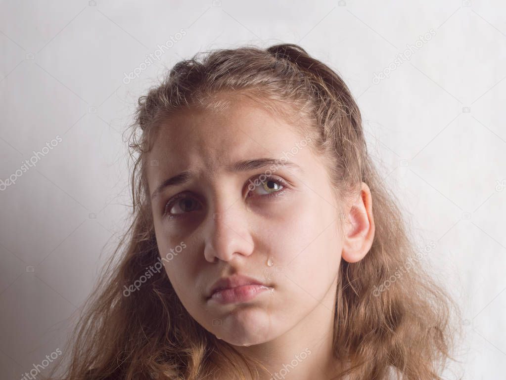 Portrait of a Sad girl on a gray background