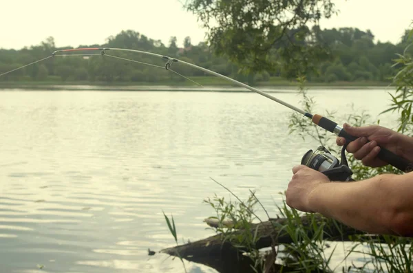 The fisherman with a fishing reel