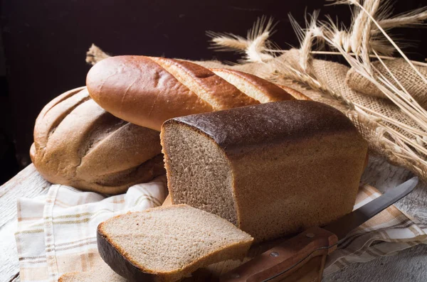 Sült kenyeret, fából készült asztal — Stock Fotó