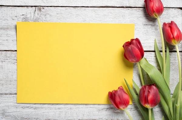 Tulips on wooden table — Stock Photo, Image