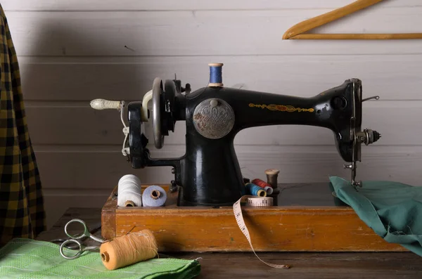 Old sewing machine, fabric and sewing thread.