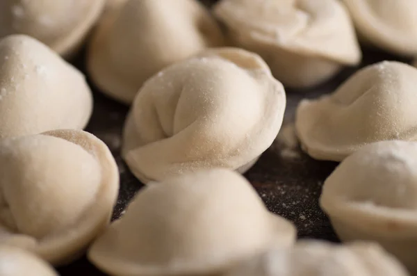 Dumplings in flour on the table — Stock Photo, Image