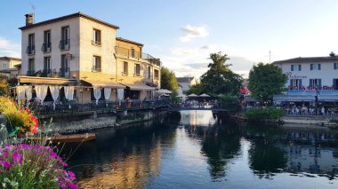 L'Isle-sur-la-Sorgue, Fransa - 2019 Ağustos, 2019: Şehir merkezinde sümerkeyfi insanlar. Köy, su kenarındaki kafe ve restoranları ile ünlüdür..