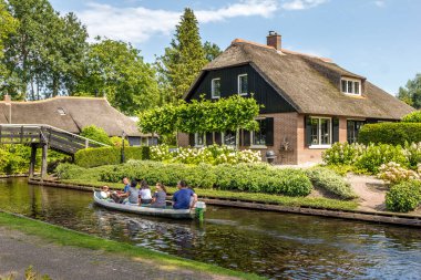 Giethoorn, Hollanda - 23 Ağustos 2017: Giethoorn 'da bir kanalda bilinmeyen ziyaretçiler. Şehir 