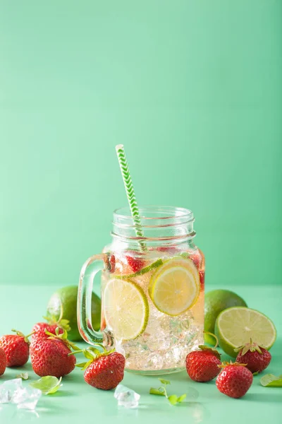 refreshing summer lemonade with strawberry and lime in mason jar