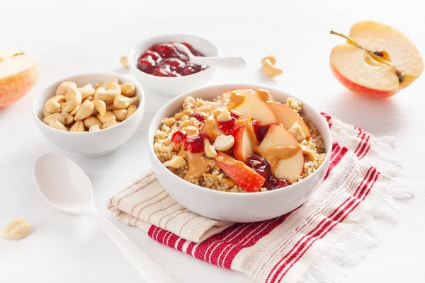 apple peanut butter quinoa bowl with jam and cashew for healthy breakfast