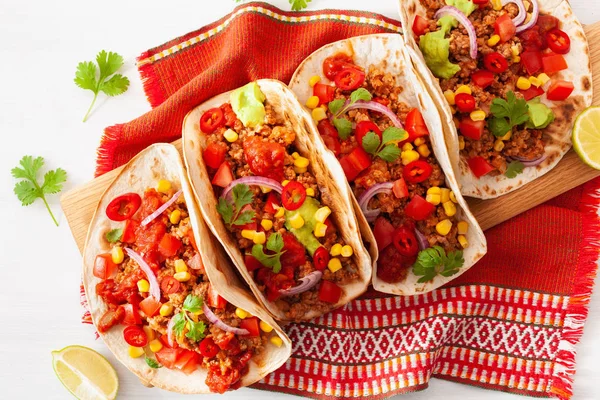 mexican beef and pork tacos with salsa, guacamole and vegetables