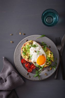 Kahvaltı avokado sandviç kızarmış yumurta ve domates ile