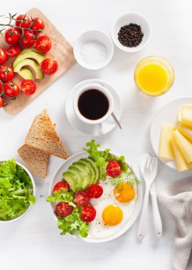 sağlıklı kahvaltı düz yatıyordu. kızarmış yumurta, avokado, domates, tost ve kahve
