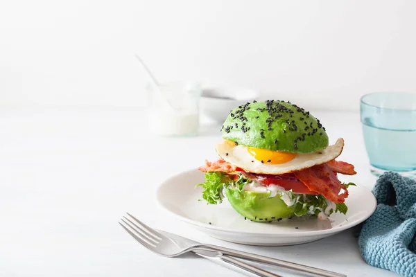 加培根、鸡蛋、西红柿的鳄梨早餐汉堡包 — 图库照片