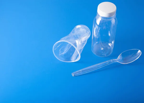 single use plastic bottles, cups, spoons. concept of recycling p