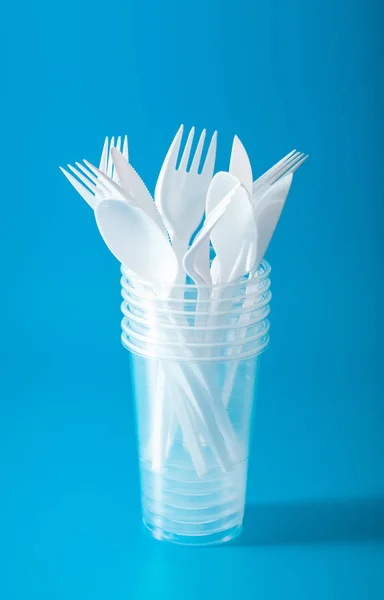 single use plastic cups, forks, spoons. concept of recycling pla