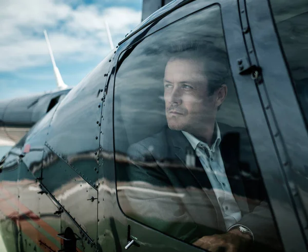 Businessman waiting inside private helicopter — Stock Photo, Image