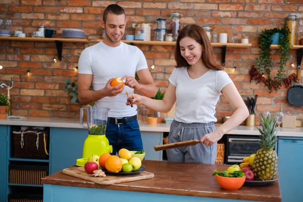 Ungt par att göra smoothie i köket — Stockfoto