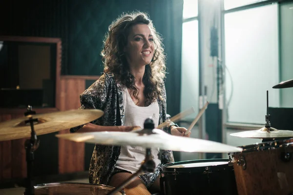 Woman playing drums during music band rehearsal — Stock Photo, Image