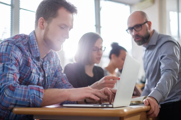 Lecturer and multinational group of students in an auditorium — Stock Photo, Image