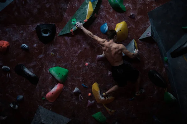 Hombre atlético practicando en un gimnasio de bouldering —  Fotos de Stock