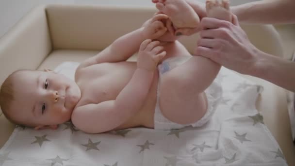 Baby boy getting a massage from masseuse — Stock Video