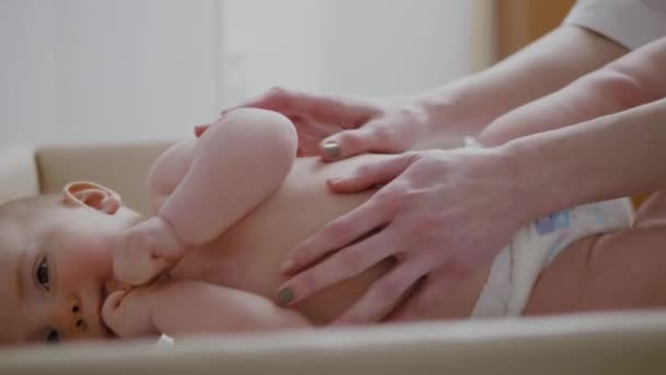 Baby boy getting a massage from masseuse — Stock Video