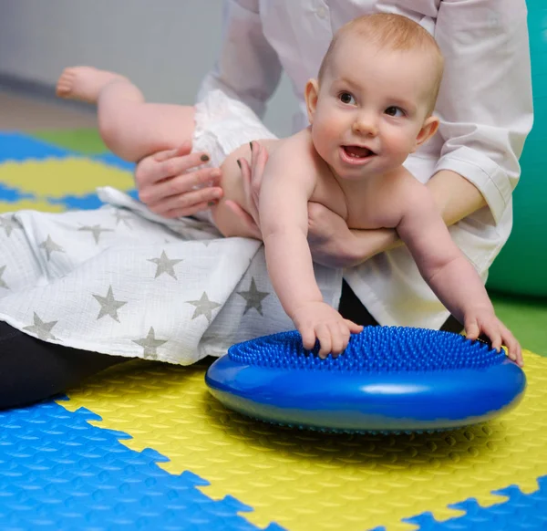 Baby boy getting massage with special equipment — Stock Photo, Image