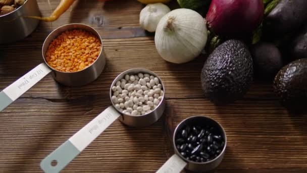 Assortment of fresh vegetables, nuts on wooden background — Stock Video
