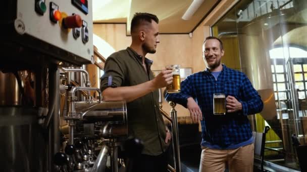 Due uomini che assaggiano birra fresca in un birrificio — Video Stock