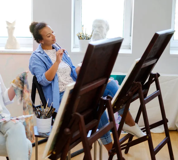 African american student working in a painting studio — Stock Photo, Image