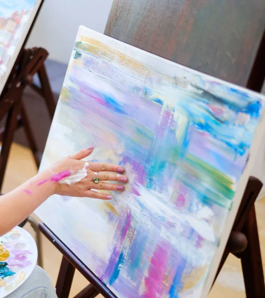 Creative painter paints a colorful picture in her studio — Stock Photo, Image