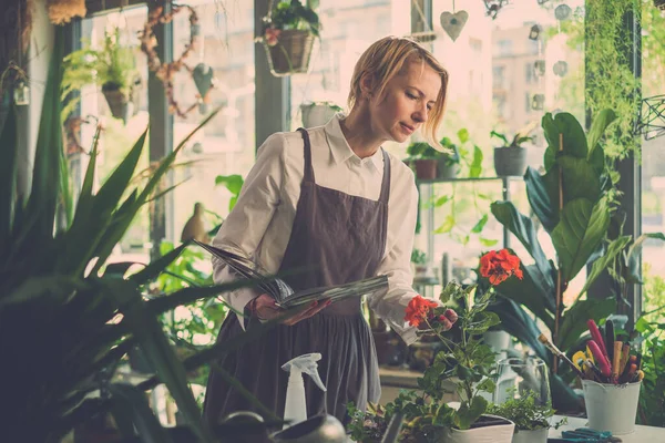 Woman Studies Plants Features From Book.