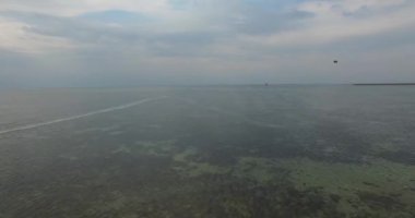 denizde parasailing, bir yükseklikten sörf uçurtma. Yukarıdan güzel deniz manzarası. Uçurtma sörfçü giyim dişli. Bir genç adam kitesurfing havadan görünümü Adaları