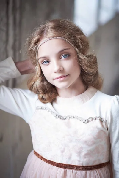 Charming little girl model posing in a studio. — Stock Photo, Image